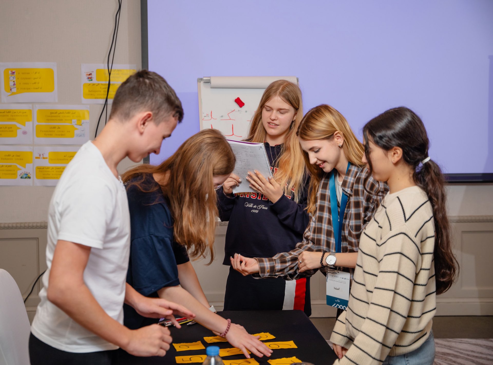 Teenagers working together on an Arabic word activity